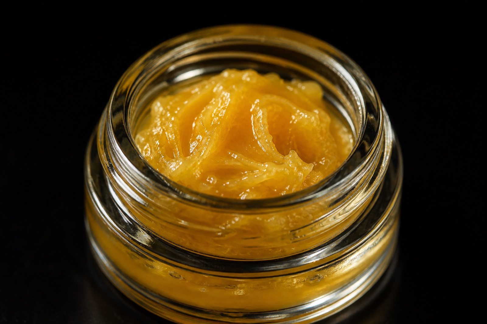 A jar of golden live rosin cannabis concentrate